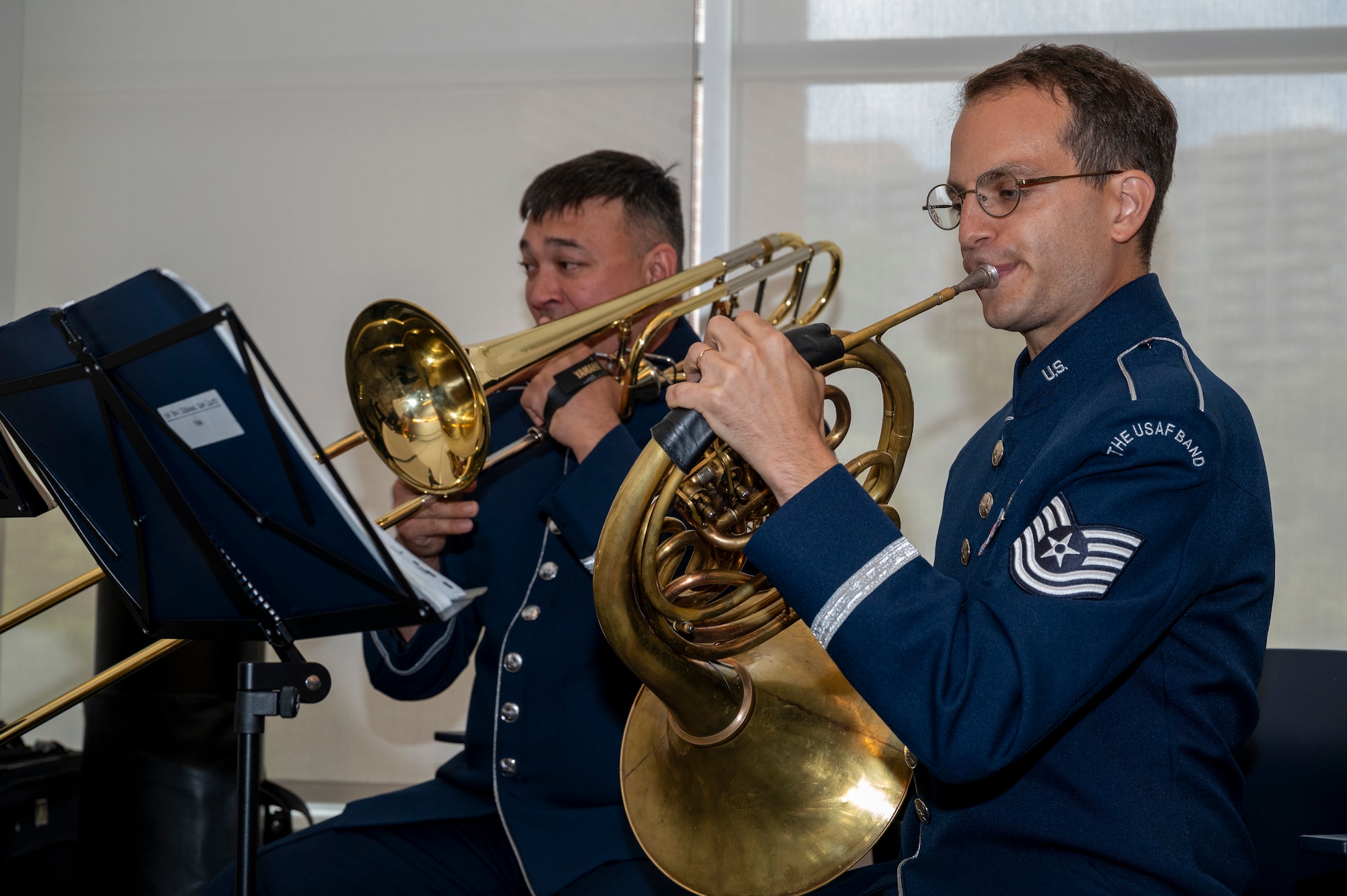 U.S. Air Force Master Sgt. Kaz Kruszewski, a trombone player, left, and Tech. Sgt. Joshua Blumenthal, a horn player, both with The U.S. Air Force Band’s Ceremonial Brass, perform during an enlistment ceremony at the Air & Space Forces Association headquarters in Arlington, Va., July 11, 2025. The performance of the Ceremonial Brass demonstrated the excellence displayed by all Airmen stationed worldwide, whose selfless service and sacrifices ensure the freedoms enjoyed by citizens of the United States of America. (U.S. Air Force photo by Hayden Hallman)