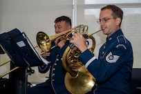 U.S. Air Force Master Sgt. Kaz Kruszewski, a trombone player, left, and Tech. Sgt. Joshua Blumenthal, a horn player, both with The U.S. Air Force Band’s Ceremonial Brass, perform during an enlistment ceremony at the Air & Space Forces Association headquarters in Arlington, Va., July 11, 2025. The performance of the Ceremonial Brass demonstrated the excellence displayed by all Airmen stationed worldwide, whose selfless service and sacrifices ensure the freedoms enjoyed by citizens of the United States of America. (U.S. Air Force photo by Hayden Hallman)