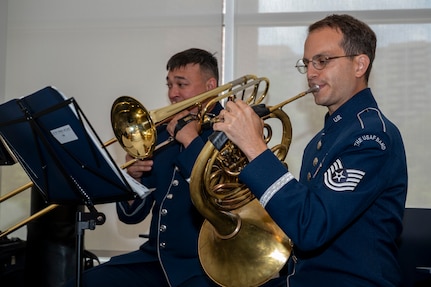 U.S. Air Force Master Sgt. Kaz Kruszewski, a trombone player, left, and Tech. Sgt. Joshua Blumenthal, a horn player, both with The U.S. Air Force Band’s Ceremonial Brass, perform during an enlistment ceremony at the Air & Space Forces Association headquarters in Arlington, Va., July 11, 2025. The performance of the Ceremonial Brass demonstrated the excellence displayed by all Airmen stationed worldwide, whose selfless service and sacrifices ensure the freedoms enjoyed by citizens of the United States of America. (U.S. Air Force photo by Hayden Hallman)