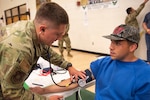 U.S. Air Force Staff Sgt. Blayne Flickinger, a medical technician assigned to the Ohio Air National Guard’s 180th medical group, takes the vitals of a local resident during the Innovative Readiness Training (IRT) Program: Operations Healthy Tennessee at Rhea County Middle School, Evensville, Tenn., July 10, 2025.