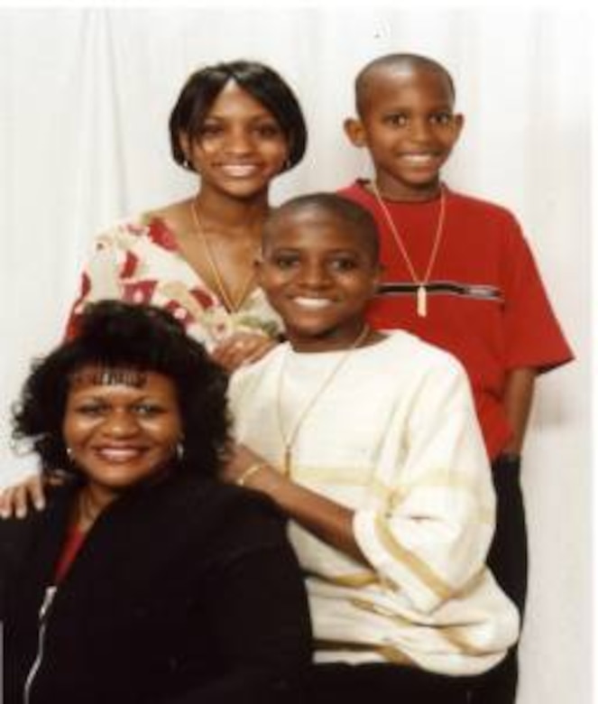 Keynote speaker Annette Young poses with her three children for a family photo.