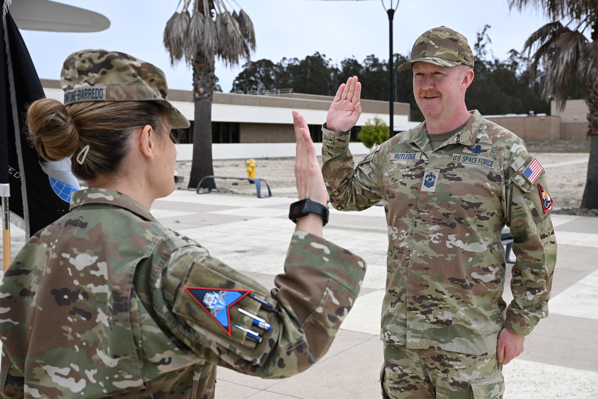 A Space Force officer administers an oath to a service member.