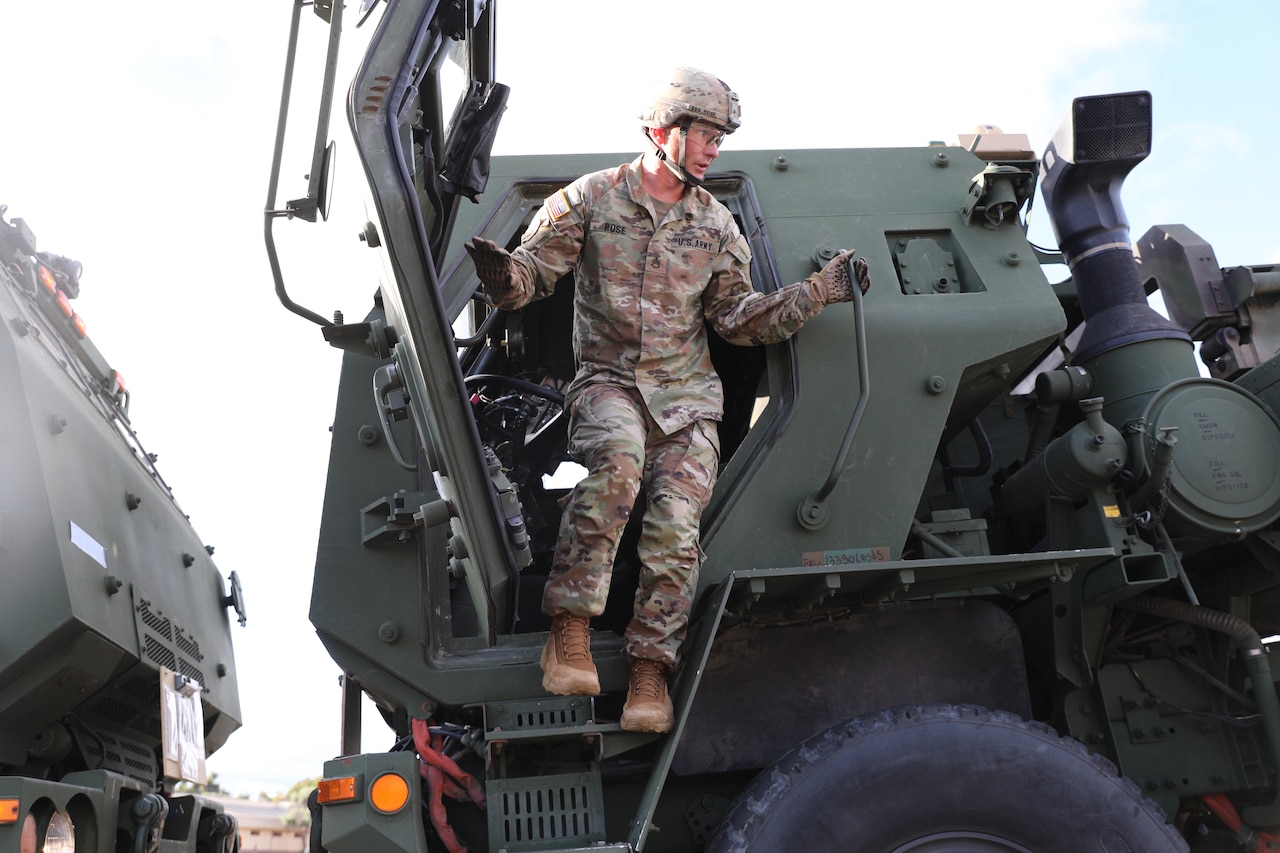 A soldier exits the driver side of a vehicle.