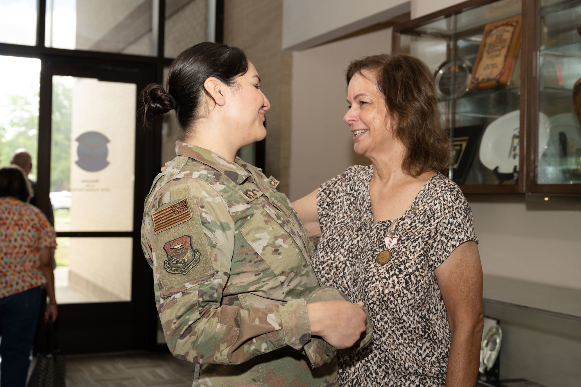 Anita Conder looks at Tech. Sgt Karina Barajas of the Inter-American Air Forces Academy, after her retirement ceremony.
