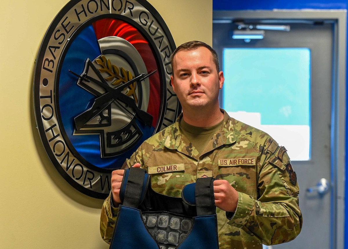 U.S. Air Force Master Sgt. Kiefer Colmer, 42nd Air Base Wing Honor Guard superintendent, presents an ice vest in the honor guard hangar at Maxwell Air Force Base, Alabama, June 23, 2025.