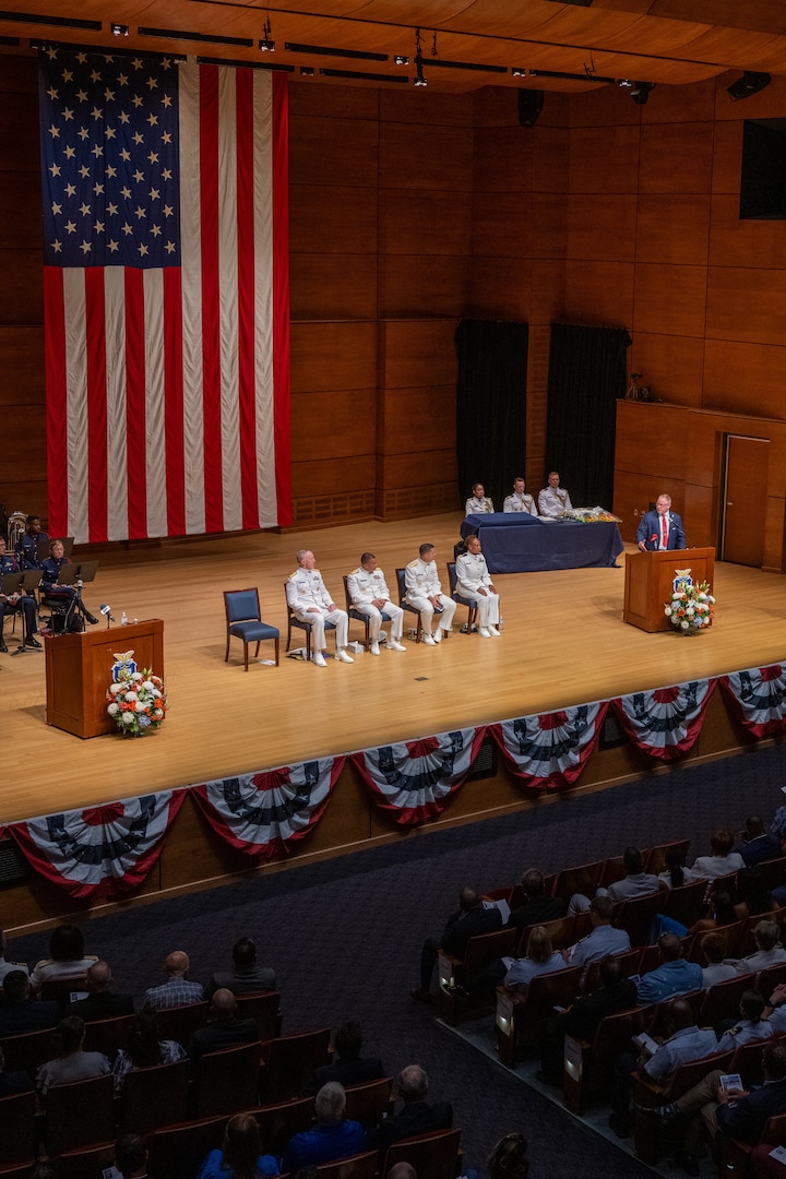 Senior Advisor to the Secretary for the Coast Guard Mr. Sean Plankey (front right to left) looks towards Lt. Netetia Walker, Rear Adm. Gregory Rothrock, Rear Adm. Michael Johnston, and Adm. Kevin Lunday during a speech at a change of command ceremony inside Leamy Hall at the U.S. Coast Guard Academy (USCGA), New London, Connecticut, July 16, 2025. Rothrock relieved Johnston as the 44th superintendent of USCGA. (U.S. Coast Guard photo by Petty Officer Third Class Leo Avila.)
