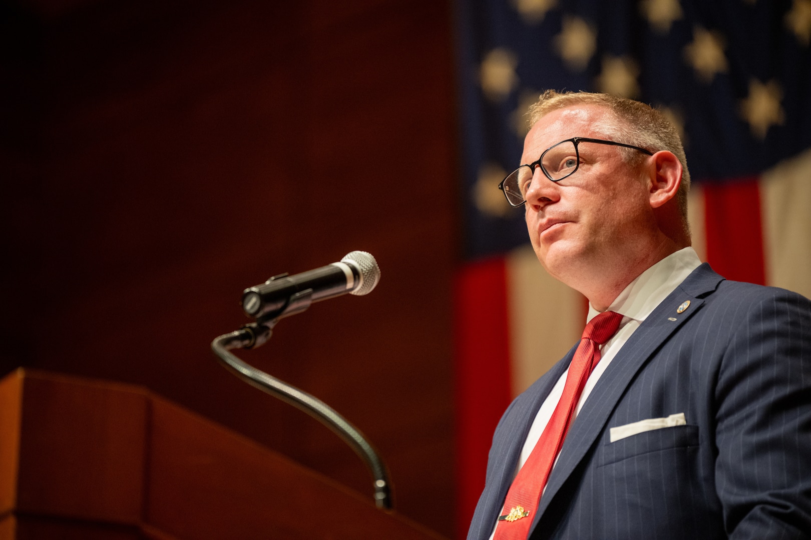 Senior Advisor to the Secretary for the Coast Guard Mr. Sean Plankey pauses during a speech during a change of command ceremony inside Leamy Hall at the U.S. Coast Guard Academy (USCGA), New London, Connecticut, July 16, 2025. USCGA Superintendent Rear Adm. Gregory Rothrock relieved Rear Adm. Michael Johnston as the 44th superintendent of USCGA. (U.S. Coast Guard photo by Petty Officer Third Class Leo Avila.)