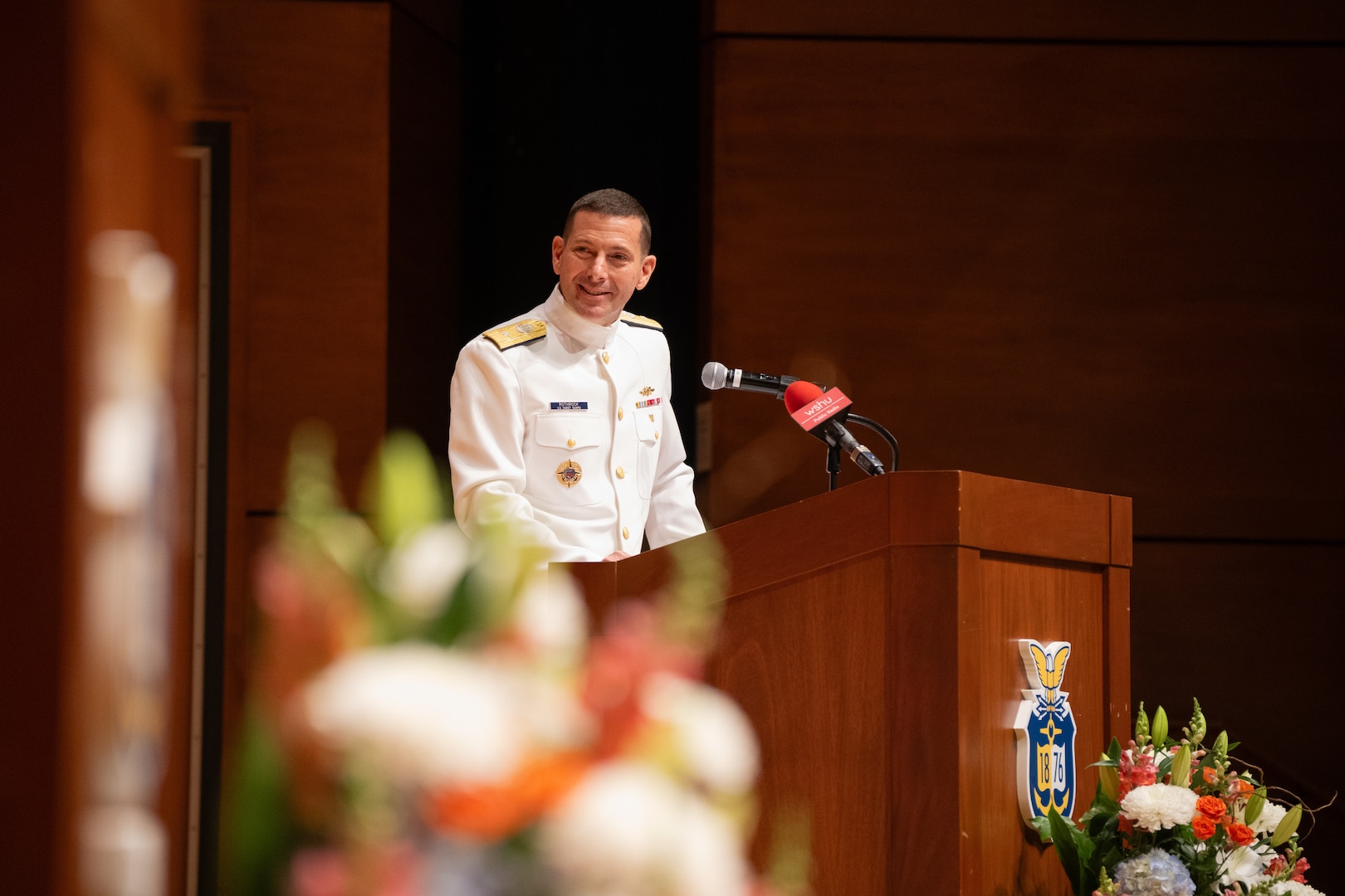 U.S. Coast Guard Academy Superintendent Rear Adm. Gregory Rothrock gives a speech during a change of command ceremony inside Leamy Hall at the U.S. Coast Guard Academy (USCGA), New London, Connecticut, July 16, 2025. Rothrock relieved Rear Adm. Michael Johnston to become the 44th superintendent of USCGA. (U.S. Coast Guard photo by Petty Officer Third Class Leo Avila.)