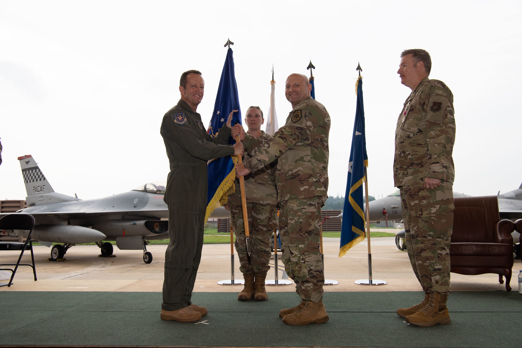 Lt. Gen. David Iverson, Seventh Air Force commander, passes the guidon to Chief Master Sgt. Thomas Schaefer, signifying his assumption of responsibility as the command chief master sergeant for Seventh Air Force during a Change of Responsibility ceremony at Osan Air Base, Republic of Korea, July 17, 2025. Schaefer brings extensive experience from various leadership roles, including a previous assignment as the command chief master sergeant of the 8th Fighter Wing at Kunsan Air Base, Republic of Korea. (U.S. Air Force photo by Staff Sgt. Dustin Braaten)