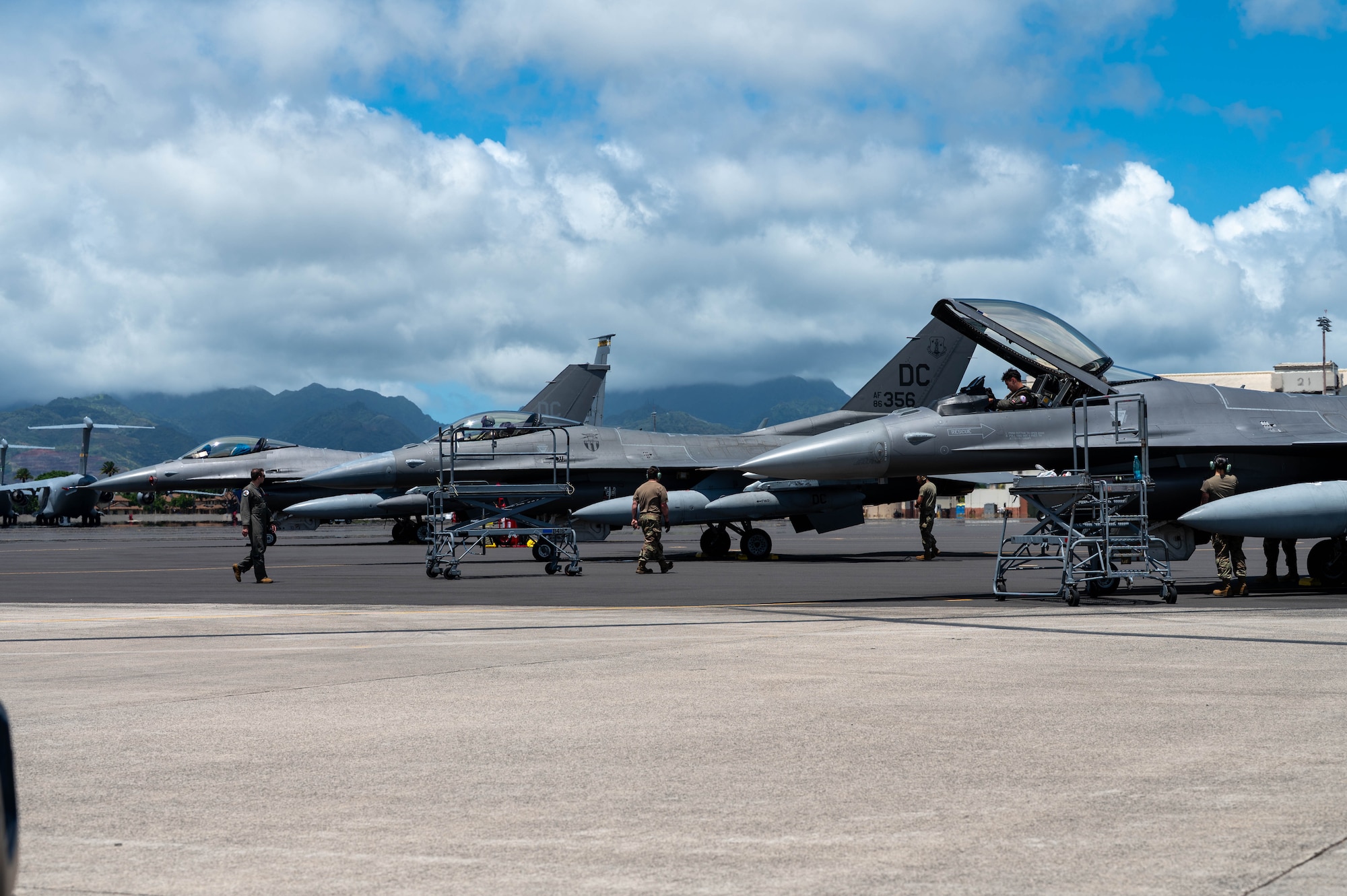 U.S. Air Force Air National Guardsmen of the 113th Wing park multiple F-16 Fighting Falcons at Joint Base Pearl Harbor-Hickam, Hawaii, during exercise Resolute Force Pacific 2025, July 11, 2025. REFORPAC is part of the first-in-a-generation Department-Level Exercise series, designed to combat airpower to the Indo-Pacific region at speed and scale, and conduct operations in a contested, dynamic environment. (U.S. Air Force photo by Senior Airman Mark Sulaica)