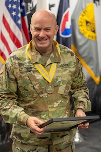 Lt. Col. Jason L. Shick, U.S. Army Financial Management Command plans and operations officer, delivers remarks after receiving a Maj. Gen. Nathan Towson Regimental Medallion at the Maj. Gen. Emmett J. Bean Federal Center in Indianapolis June 2, 2025. The Towson was established by the U.S. Army Finance Corps Association on May 7, 1993, to recognize exceptional achievement or exemplary service by currently serving U.S. Army finance and comptroller commissioned officers, non-commissioned officers, enlisted Soldiers and civilians demonstrating exceptional leadership and whose accomplishments clearly distinguish them from their peers. (U.S. Army photo by Mark R. W. Orders-Woempner)