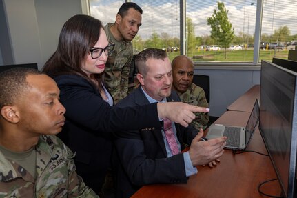 From left to right, Maj. Terrell Murdock, U.S. Army Financial Management Command banking officer; Angie Maldonado, USAFMCOM audit support specialist; Scott Ferge, Office of the Assistant Secretary of the Army for Financial Management and Comptroller accountant; Master Sgt. Sitanimoa Filimoeulie, 45th Finance Center finance operations manager; and Sgt. Maj. Alphanzo Hunter, USAFMCOM Operations senior enlisted advisor, have a discussion at the Maj. Gen. Emmett J. Bean Federal Center May 1, 2025. USAFMCOM directly supports the OASA (FM&C) in their role as the principal advisor on all matters related to financial management and comptrollership. (U.S. Army photo illustration by Mark R. W. Orders-Woempner)