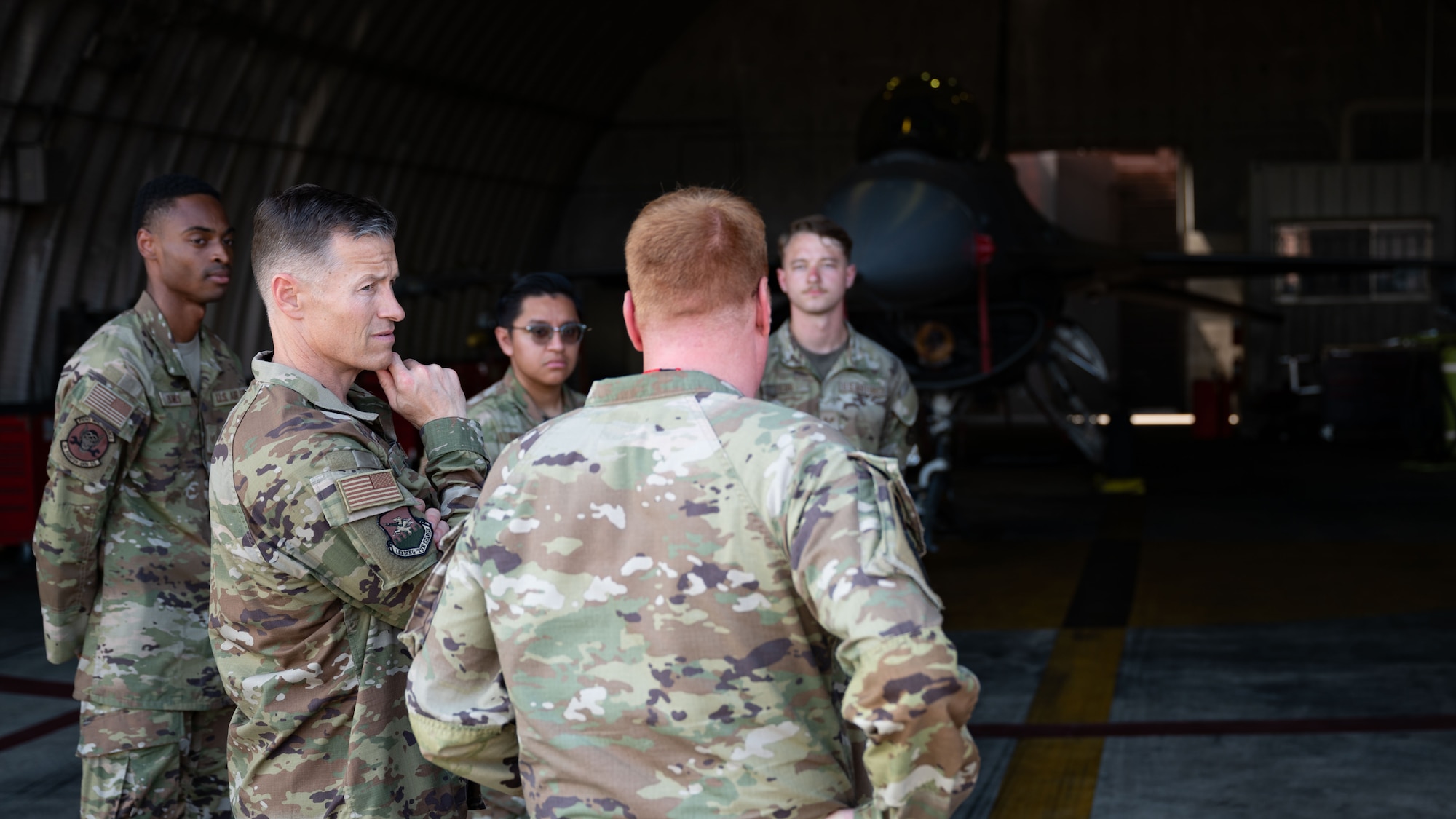 U.S. Air Force Col. Ryan Ley, center left, 51st Fighter Wing commander, receives a briefing from Maj. Richard Ryland, center right, 36th Fighter Generation Squadron commander, at Osan Air Base, Republic of Korea, July 9, 2025. As the largest F-16 Fighting Falcon FGS in the USAF, the 36th FGS plays a crucial role in the delivery of combat air power on the Korean peninsula, but also in the development of the super-squadron concept. (U.S. Air Force photo by Senior Airman Rome Bowermaster)