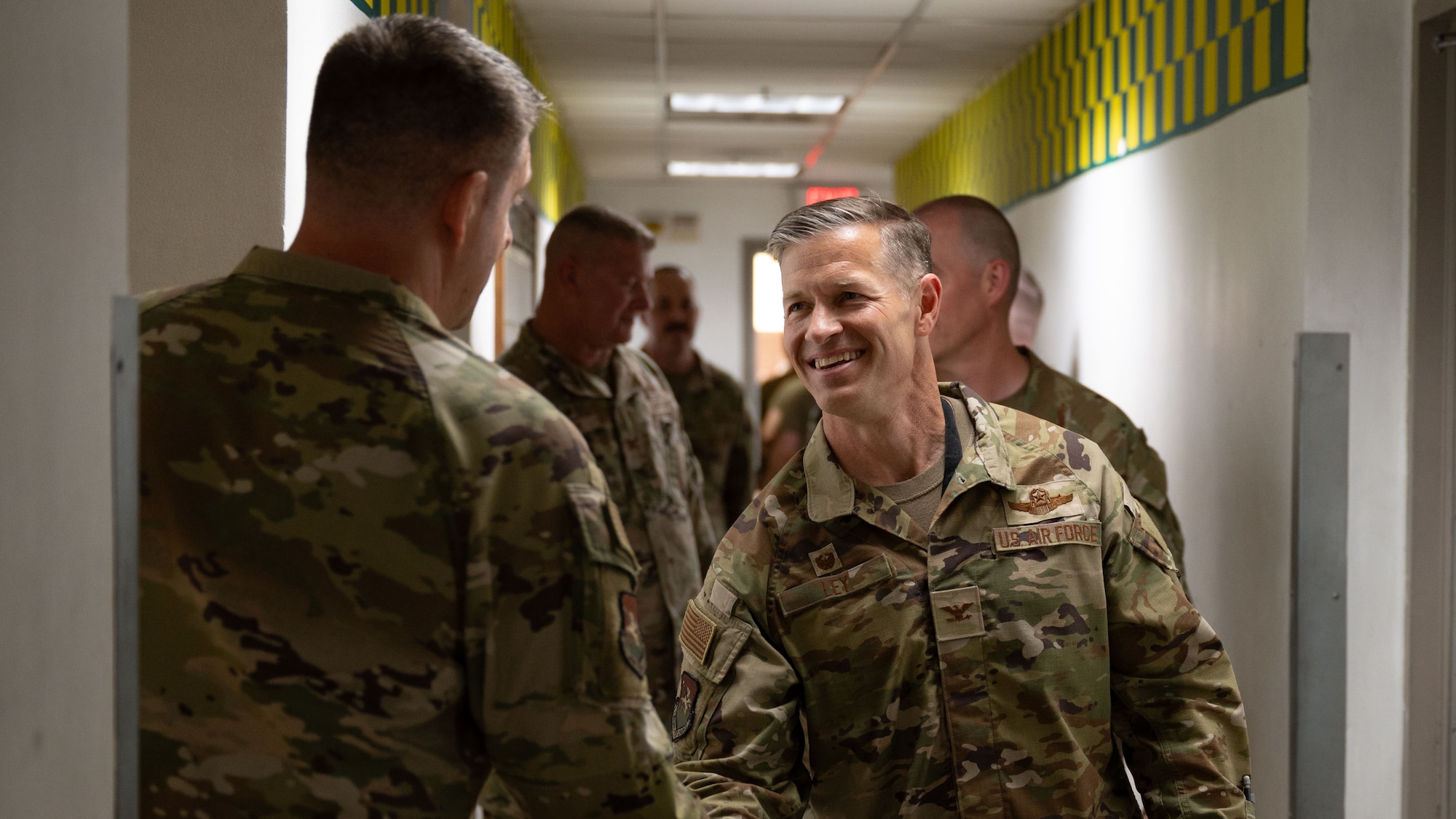 U.S. Air Force Col. Ryan Ley, 51st Fighter Wing commander, right, shakes hand with a service member assigned to the 25th Fighter Generation Squadron, at Osan Air Base, Republic of Korea, July 9, 2025. 