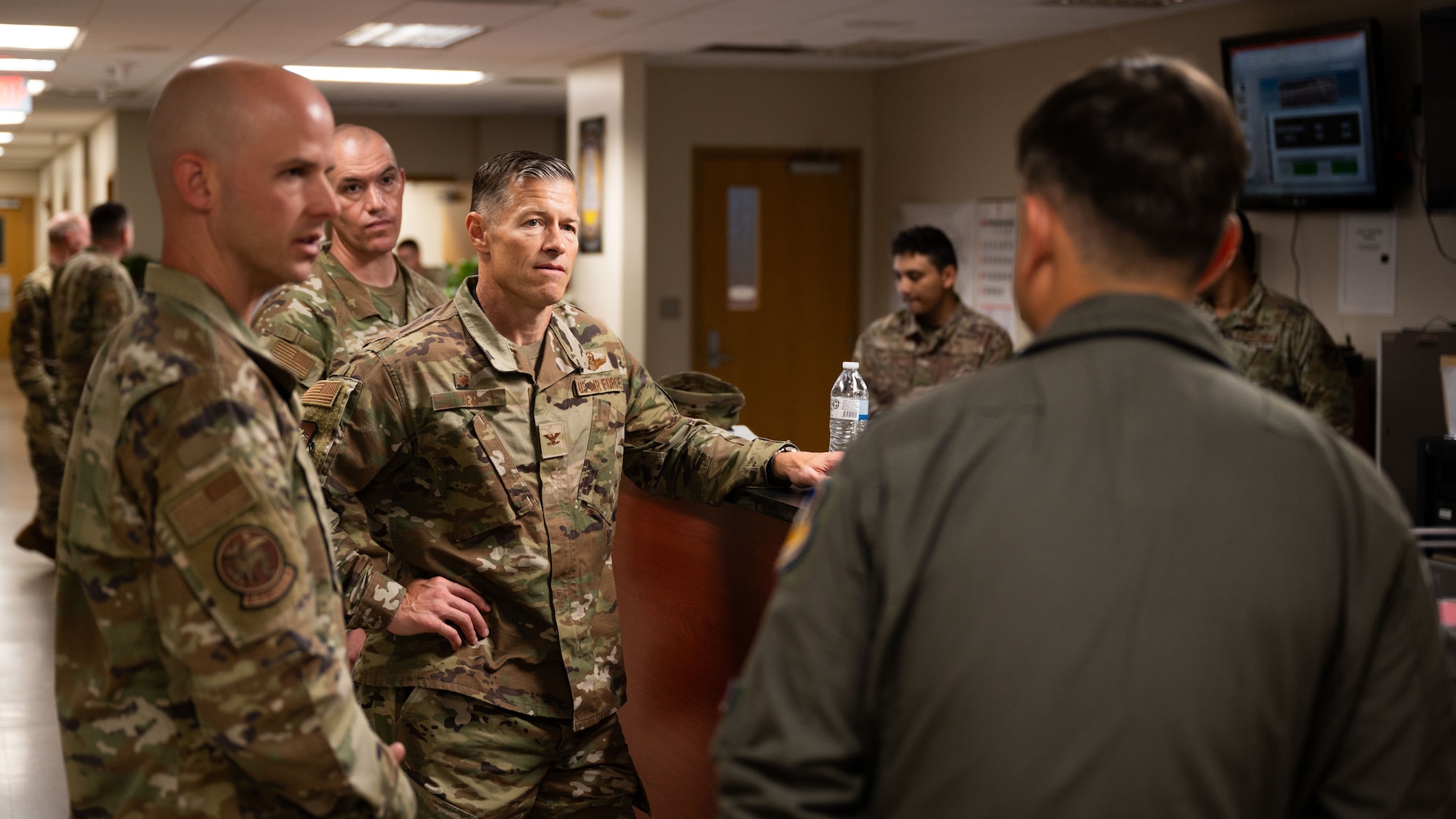 U.S. Air Force Col. Ryan Ley, center, 51st Fighter Wing commander, discusses flightline operations with Lt. Col. Lance Tucker, 51st Operations Support Squadron commander, at Osan Air Base, Republic of Korea, July 15, 2025. Ley’s immersion with the 51st OSS provided valuable insight into how flightline operations contribute to mission success in the air. (U.S. Air Force photo by Senior Airman Rome Bowermaster)
