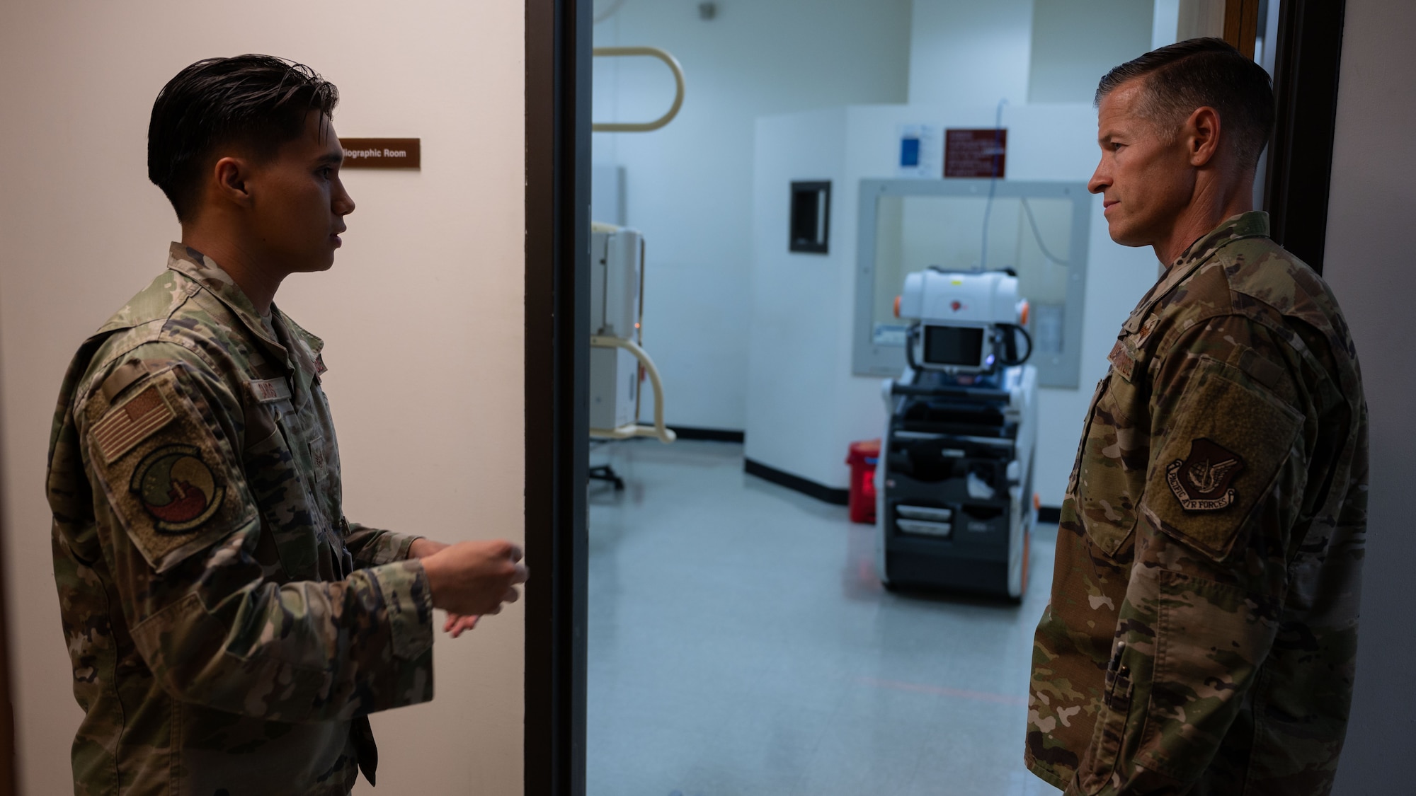 U.S. Air Force Staff Sgt. Leaaron Santos, left, 51st Healthcare Operations Squadron diagnostic imaging technologist, provides a radiology brief to Col. Ryan Ley, right, 51st Fighter Wing commander, at Osan Air Base, Republic of Korea, July 15, 2025. The radiology department provides a range of imaging services, including radiography, computed tomography, and ultrasound, to support comprehensive patient care. (U.S. Air Force photo by Senior Airman Rome Bowermaster)