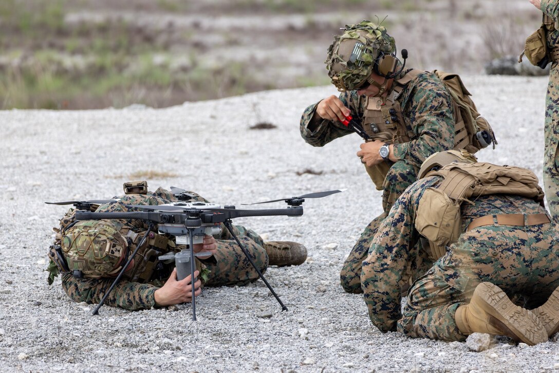 U.S. Marines with Advanced Infantry Training Battalion, School of Infantry – East load a Mjolnir munitions system on an R80D SkyRaider small unmanned aircraft system (SUAS) during a combined arms live-fire training exercise involving the employment of SUAS to deliver munitions on designated targets at Camp Lejeune, North Carolina, July 3, 2025. This event marked the first time munitions were employed from SUAS during a live-fire training exercise on Camp Lejeune, demonstrating the capability of integrating aerial strike capabilities at the tactical level. (U.S. Marine Corps photo by Cpl. Zachariah Ferraro)