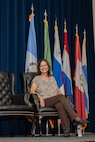 Anita Conder smiles while sitting on stage during her retirement ceremony.