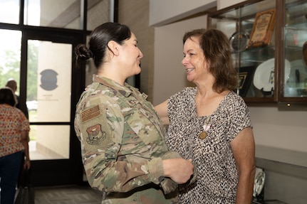 Anita Conder looks at Tech. Sgt Karina Barajas of the Inter-American Air Forces Academy, after her retirement ceremony.