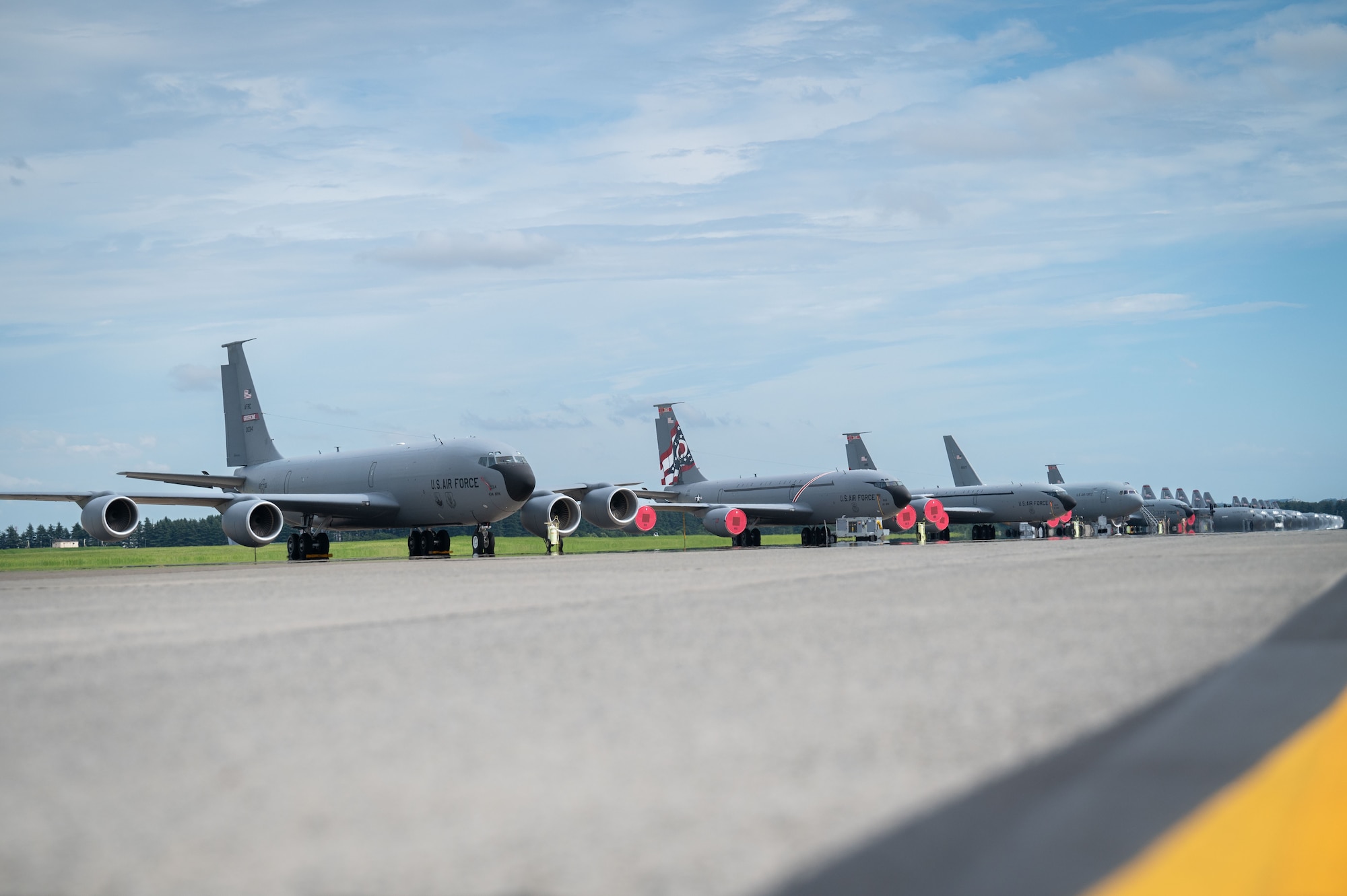 A photo of U.S. Air Force KC-135 Stratotankers, KC-46A Pegasus, C-130J Super Hercules, and C-130H Hercules aircraft.