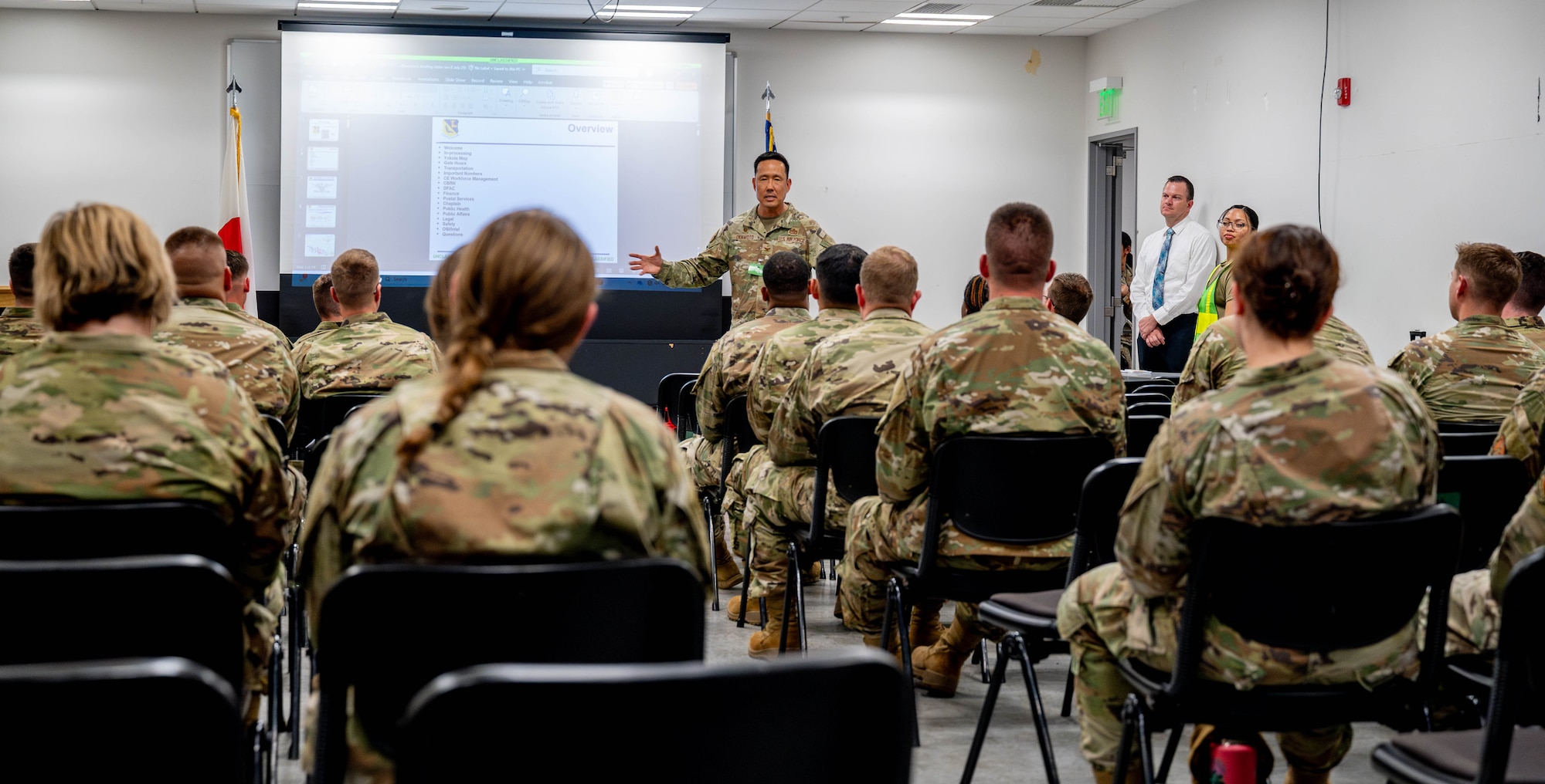 A military member briefs incoming deployed personnel.