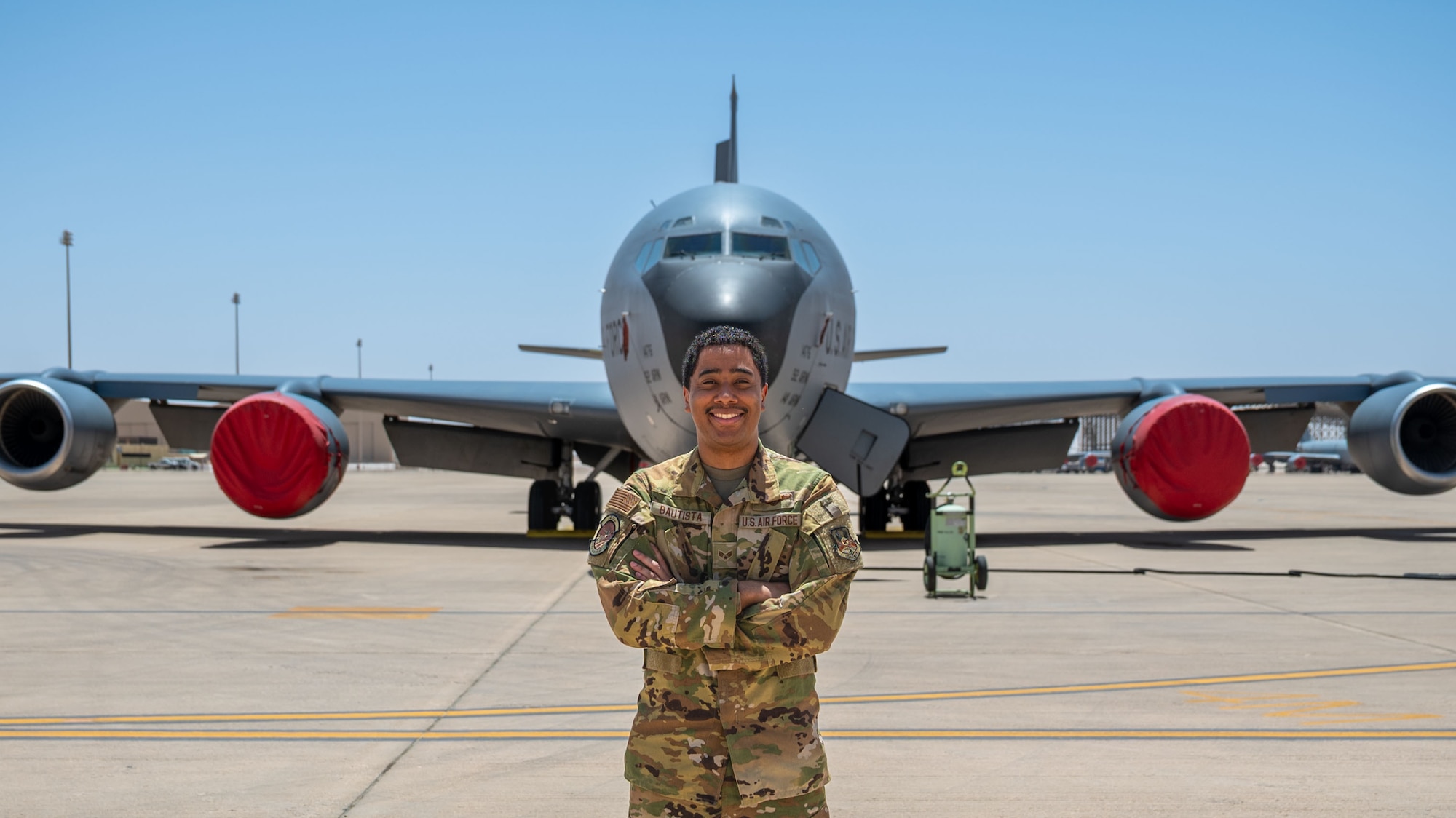 Senior Airman Gabriel Bautista, 93rd Expeditionary Aerial Refueling Squadron boom operator, poses for a portrait in front of a KC-135 Stratotanker.