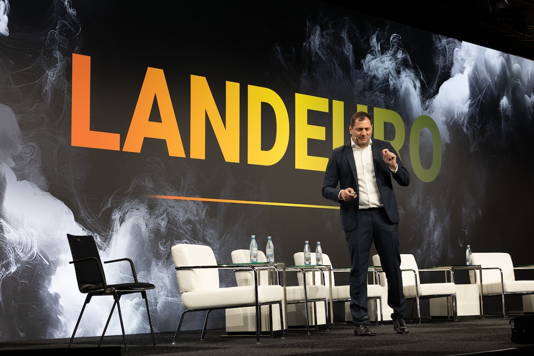Giorgi Tskhakaia, adviser to the Minister of Digital Tranformation of Ukraine, speaks to an audience of Allies and industry personnel during a Keynote Presentation at LANDEURO at the RheinMain CongressCenter in Wiesbaden, Germany, July 16, 2025. LANDEURO brings together industry and Allies to shape and accelerate industrial resilience, strengthening NATO’s force posture, and reinforcing global deterrence.  LANDEURO is the launchpad, and USAREUR-AF is the test bed for joint transformation. (U.S. Army photo by Sgt. 1st Class Christopher Osburn)