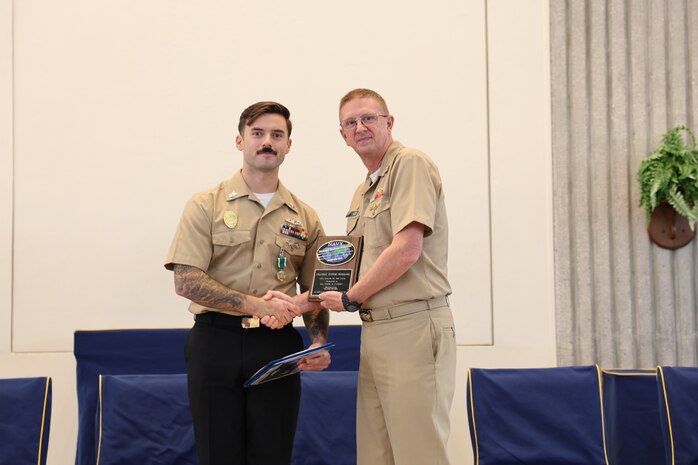 Vice Adm. Johnny Wolfe Jr. (right), Director, Strategic Systems Programs (DIRSSP), presents the DIRSSP Shore Sailor of the Year Award to Master-At-Arms First Class Tyler Cassidy (left), Marine Corps Security Force Battalion Kings Bay, during a celebratory event hosted by Strategic Weapons Facility, Atlantic (SWFLANT) at the Naval Submarine Base Kings Bay, Ga. chapel on July 3, in honor of the 70th anniversary of Strategic Systems Programs (SSP). Marine Corps Security Force Battalion Kings Bay secures strategic assets within SWFLANT’s area of responsibility in order to prevent unauthorized access or loss of control.