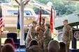 Col. Caleb Lewis, incoming commander, Letterkenny Army Depot, left, receives the flag from Maj. Gen. Lori Robinson, commanding general, U.S. Army Aviation and Missile Command, center, during a change of command ceremony held at the installation’s recreation area, assuming command of LEAD, July 10.