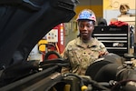 U.S. Army Spc. Massan Signon, wheeled vehicle mechanic (91B) with the D.C. National Guard’s 104th Maintenance Company, stands for a photograph at the Combined Support Maintenance Shop at Joint Base Anacostia-Bolling, in Washington, D.C., on June 21, 2025. Spc. Signon is part of a dedicated team that performs routine maintenance, emergency repairs, and recovery operations, which are vital for keeping the Army's vehicles operational and ready for deployment at a moment's notice. Their work directly impacts the ability to respond to missions.