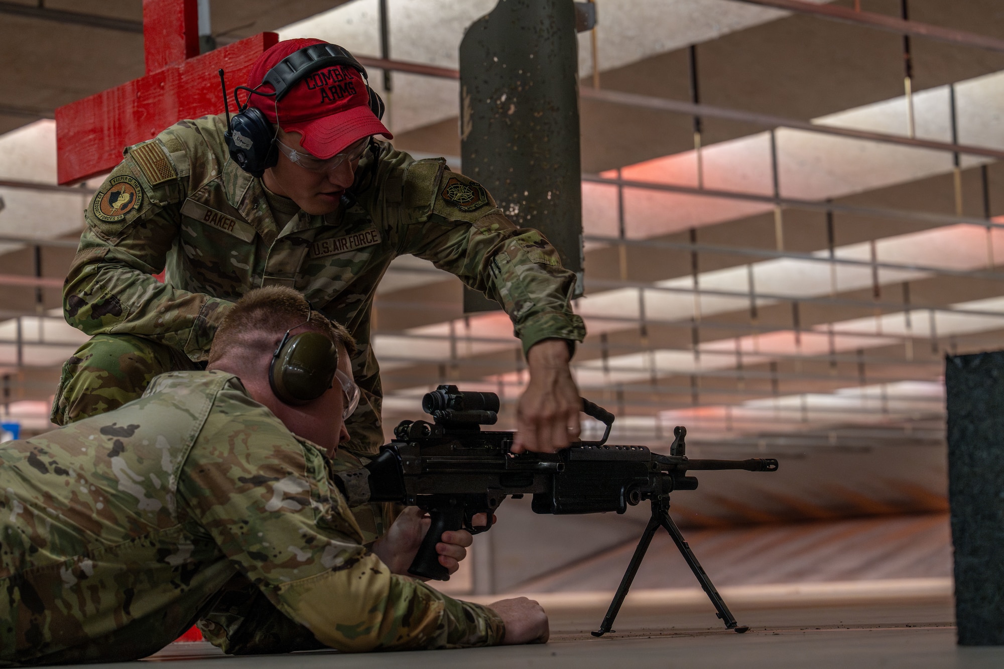Staff Sgt. Jacob Baker, 184th Security Forces Squadron Combat Arms Training and Maintenance instructor, instructs an Airman Leadership School Class 25-F student on the proper use of a M-249 machine gun during an ALS trip to the CATM facility at McConnell Air Force Base, Kansas, July 10, 2025. The trip aimed to build cross-functional readiness in the future leaders. (U.S. Air Force photo by Airman 1st Class Paula Arce)