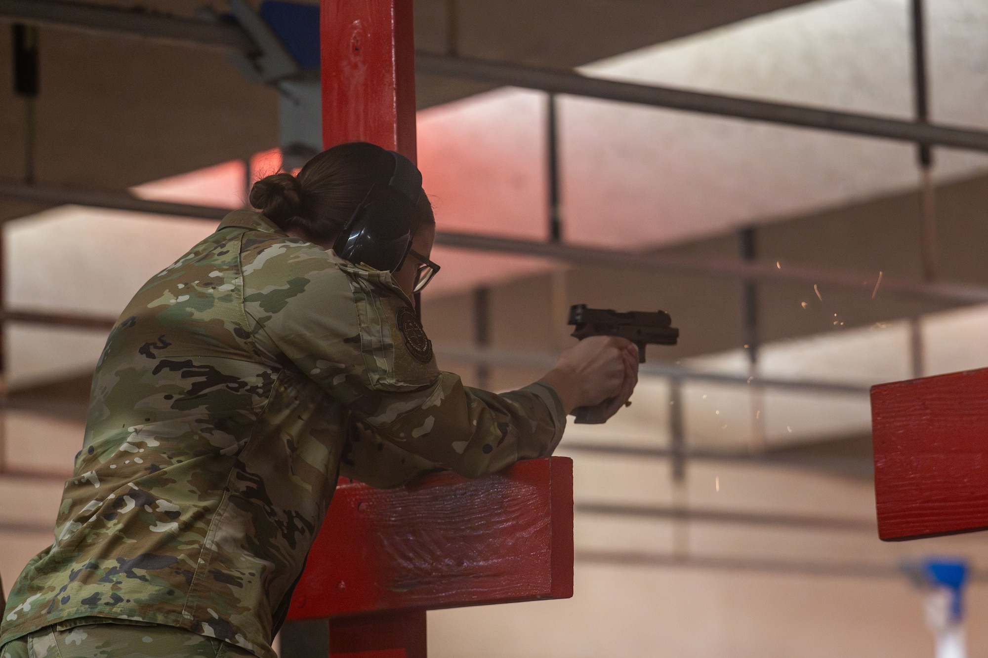Senior Airman Ashlyn Rogosheske, 22nd Healthcare Operations Squadron aerospace medical technician, fires a Glock 19 pistol during an Airman Leadership School Class 25-F trip to the Combat Arms Training and Maintenance facility at McConnell Air Force Base, Kansas, July 10, 2025. The ALS students participated in a K-9 demo and a hands-on range experience to gain weapon familiarization and learn about base defense capabilities. (U.S. Air Force photo by Airman 1st Class Paula Arce)