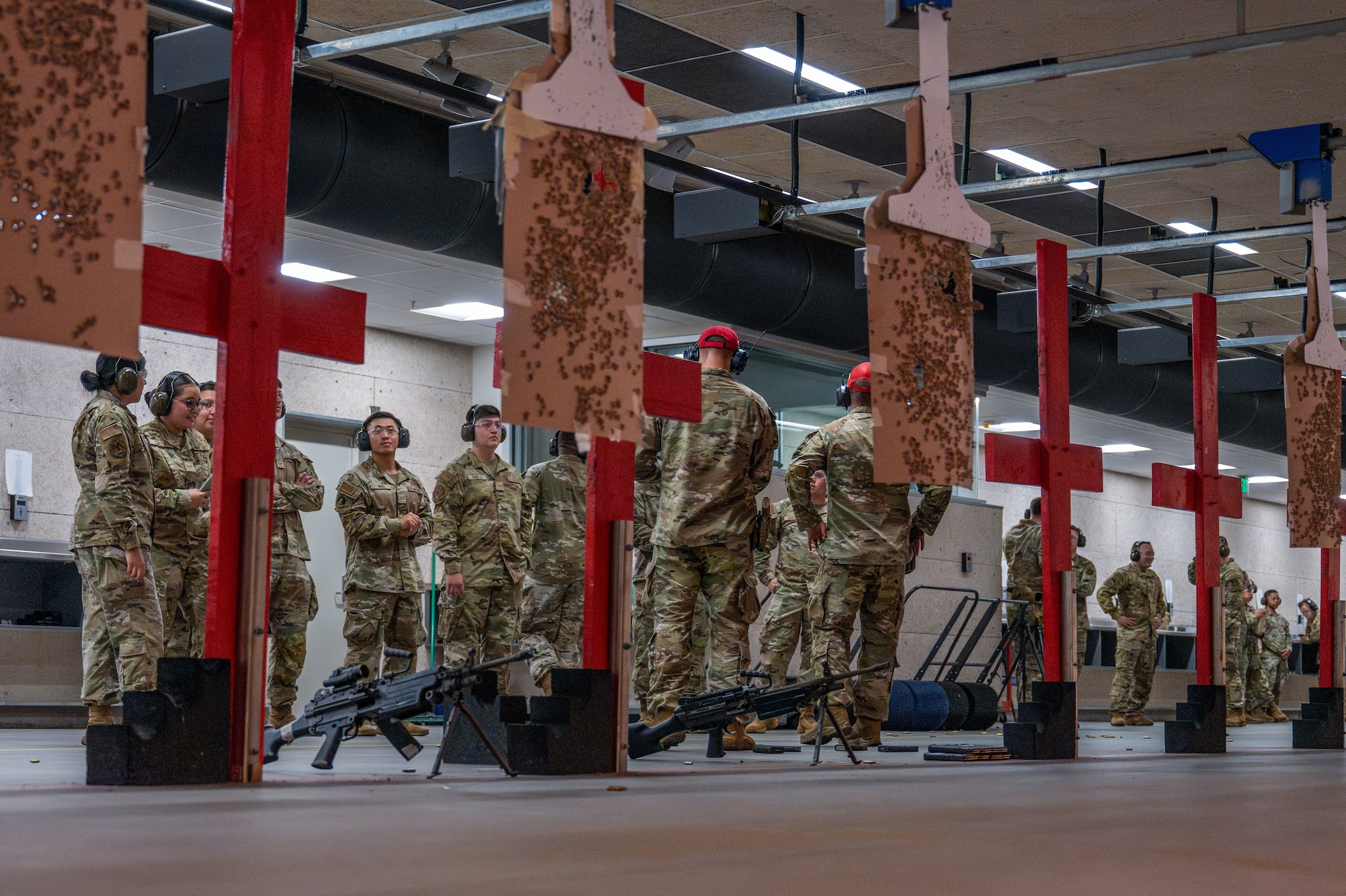 Combat Arms Training and Maintenance instructors brief Airman Leadership School Class 25-F students on a variety of weapons at McConnell Air Force Base, Kansas, July 10, 2025. The field trip, not generally part of the ALS curriculum, gave Airmen from multiple career fields an opportunity to learn about the weapons used to protect the installation. (U.S. Air Force photo by Airman 1st Class Paula Arce)