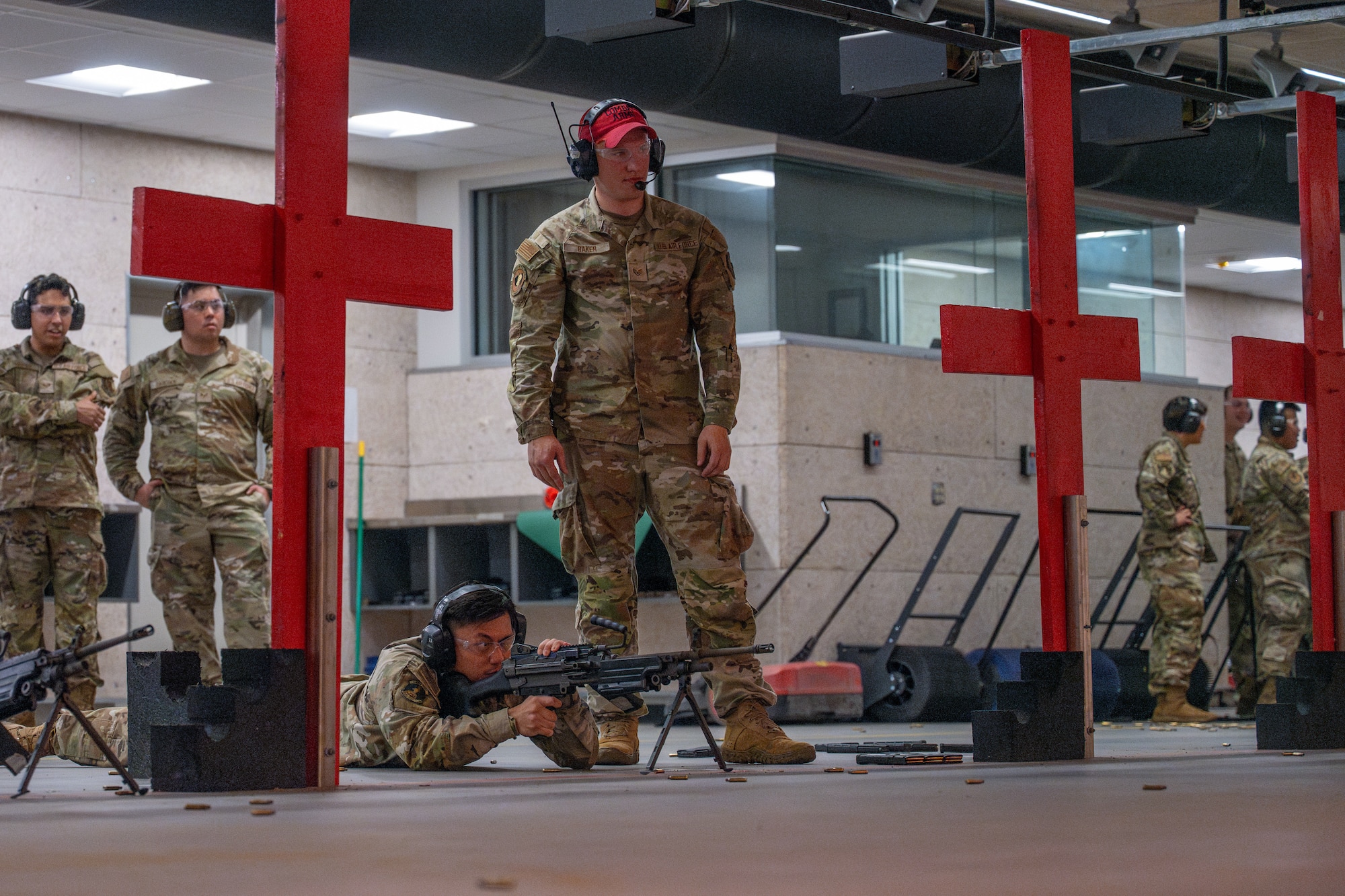 Airman Leadership School Class 25-F students take turns firing a M-249 machine gun during an ALS trip to the Combat Arms Training and Maintenance facility at McConnell Air Force Base, Kansas, July 10, 2025. The trip aimed to build cross-functional readiness in the future leaders. (U.S. Air Force photo by Airman 1st Class Paula Arce)