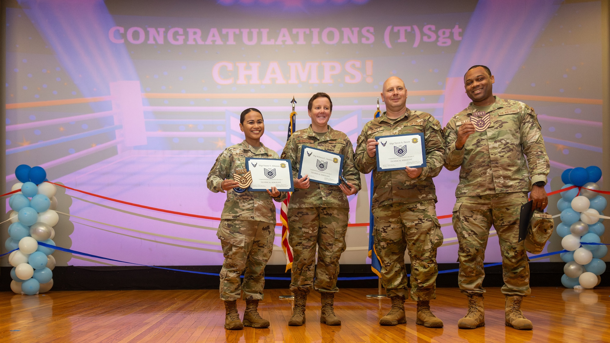Airmen pose for photo during promotion ceremony.