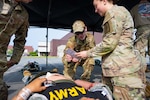 New York Air and Army National Guard medical personnel examine a “casualty’s ” triage tag before loading victim into the  cargo bay of a 105th Airlift Wing Globemaster III airlifter at Stewart Air National Guard Base in Newburgh, New York, on June 6, 2025 during a medical evacuation training exercise. The Army Army and Air Guard medical personnel joined Active Soldiers from Keller Army Community Hospital at West Point in conducting a “tail-to-tail” drill in which casualties were off-loaded directly from an Army Medevac helicopter into the C-17.