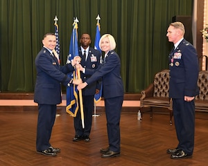 16th Air Force commander passes unit guidon to new 688th CW commander.