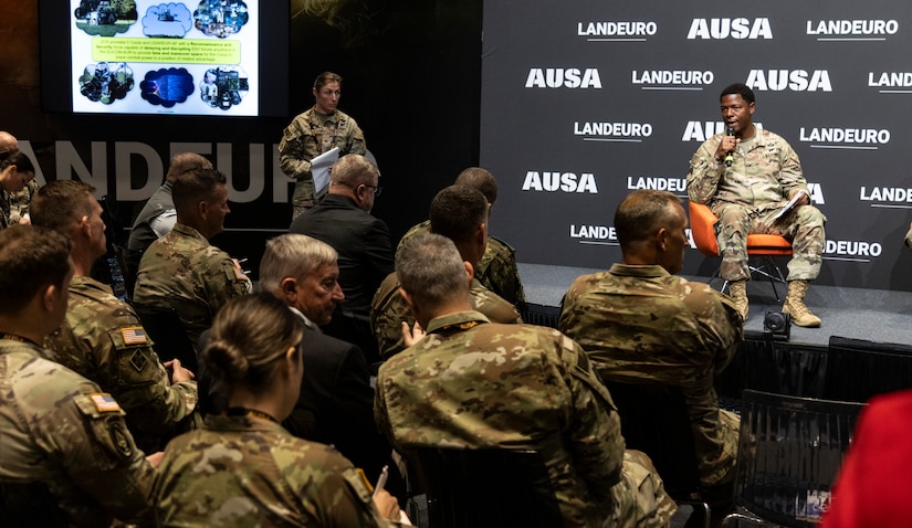 Warrant Officer 1 Harley Upham of the British Army, assigned as the command sergeant major of NATO’s Allied Rapid Reaction Corps, speaks during a senior enlisted leadership panel at LANDEURO’s Warriors Corner in Wiesbaden, Germany, July 16, 2025. Panelists addressed how NCOs can lead through transformation while reinforcing core warfighting skills and multinational cooperation across NATO formations. (U.S. Army photo by Sgt. Tyler Brock)