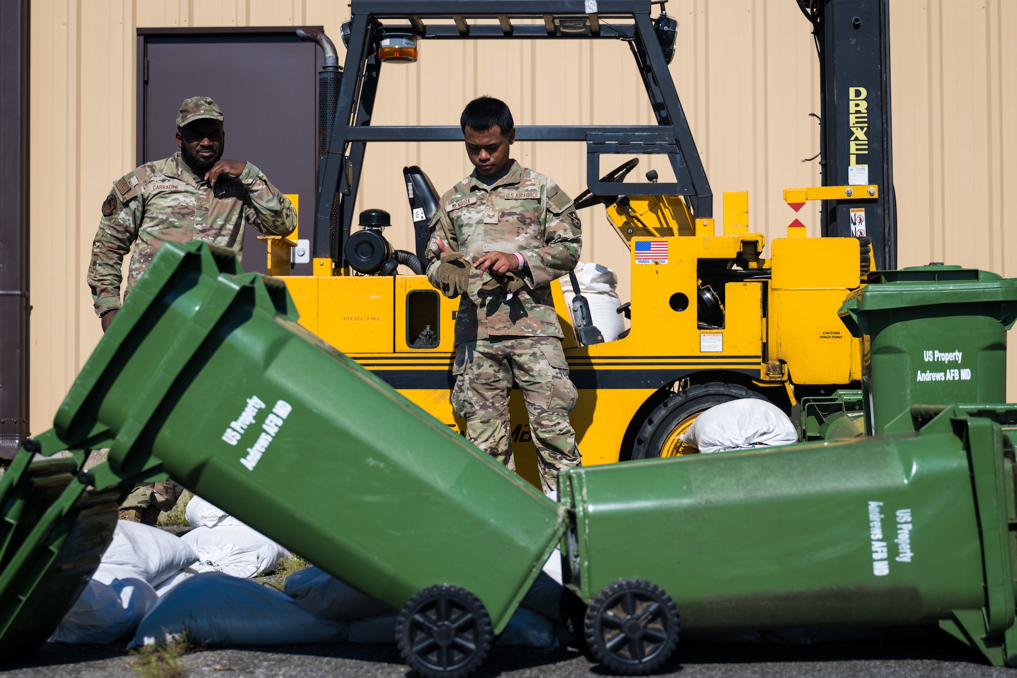 Senior Airman Kervee Mendoza, puts on gloves before constructing a defensive fighting position.