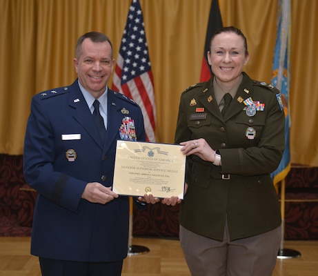 Maj. Gen. David Sanford and Col. Adrian J. Sullivan pose with a certificate between them