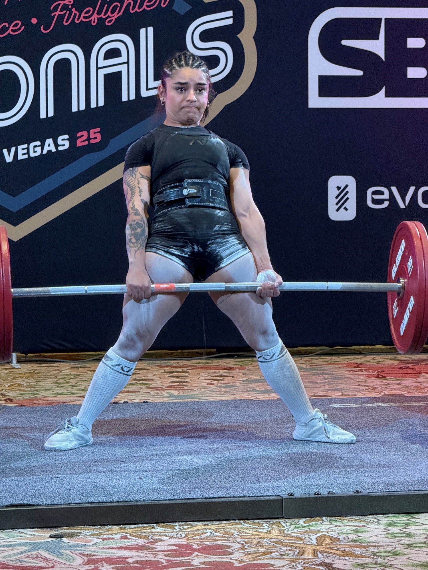 Two women powerlifters pose for photo