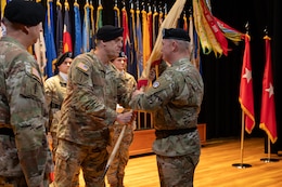 Command Sgt. Maj. Peter Lepley, senior enlisted advisor, 1st Theater Sustainment Command, passes the unit colors to outgoing commanding general, Maj. Gen. Eric P. Shirley, 1st TSC, during the change of command ceremony at Fort Knox, June 26, 2025.