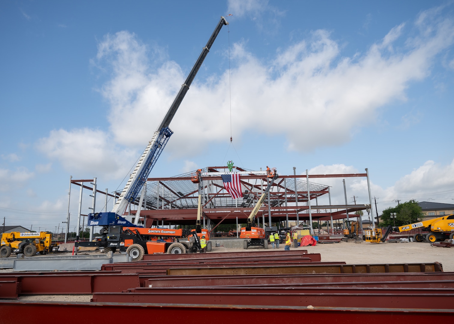 Contractors raise the final steel beam into place at the future Dunn Dental Clinic during a topping-out ceremony at Joint Base San Antonio-Lackland, Texas, July 16, 2025.