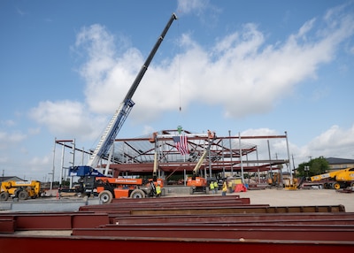 Contractors raise the final steel beam into place at the future Dunn Dental Clinic during a topping-out ceremony at Joint Base San Antonio-Lackland, Texas, July 16, 2025.