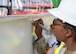 Brig. Gen. Gwendolyn "Fiend" Foster, director of the San Antonio Military Health System and 59th Medical Wing commander, signs the final steel beam during the Dunn Dental Clinic topping out ceremony near Joint Base San Antonio-Lackland, Texas, July 16, 2025.