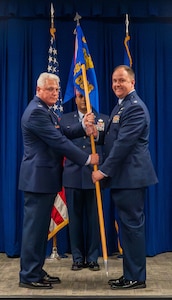 a person hands another a flag