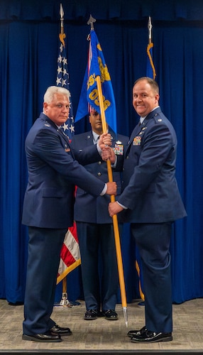 a person hands another a flag