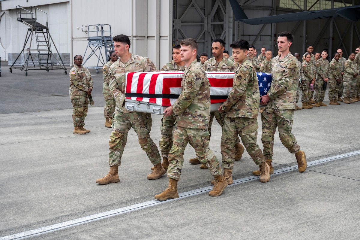 McChord Field Base Honor Guard Airmen demonstrate the simulated carrying of a remains case during a dignified transfer ramp ceremony training at Joint Base Lewis-McChord, Washington, July 10, 2025.