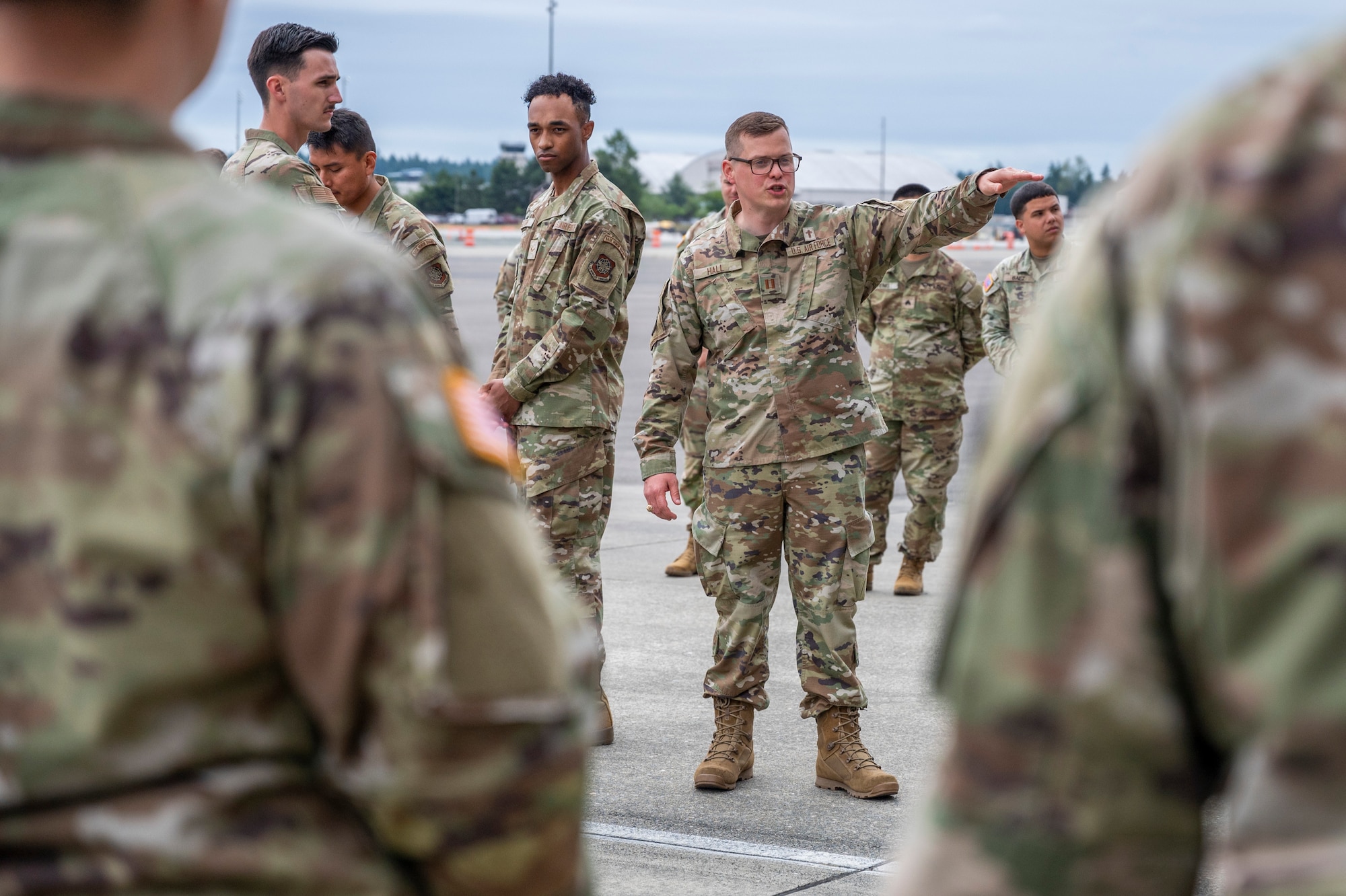 U.S. Air Force Capt. Daniel Hall, Team McChord chaplain, directs a dignified transfer ramp ceremony training at Joint Base Lewis-McChord, Washington, July 10, 2025.
