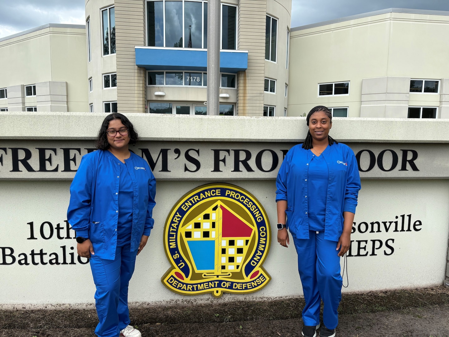 Carol Urbano (left) and Metuschelah Francois (right), phlebotomy externs, pose in front of Jacksonville MEPS. The Jacksonville MEPS team welcomed the first two phlebotomy externs to help assist with collecting vitals, drawing blood and urine samples and conducting vision and audio screenings.